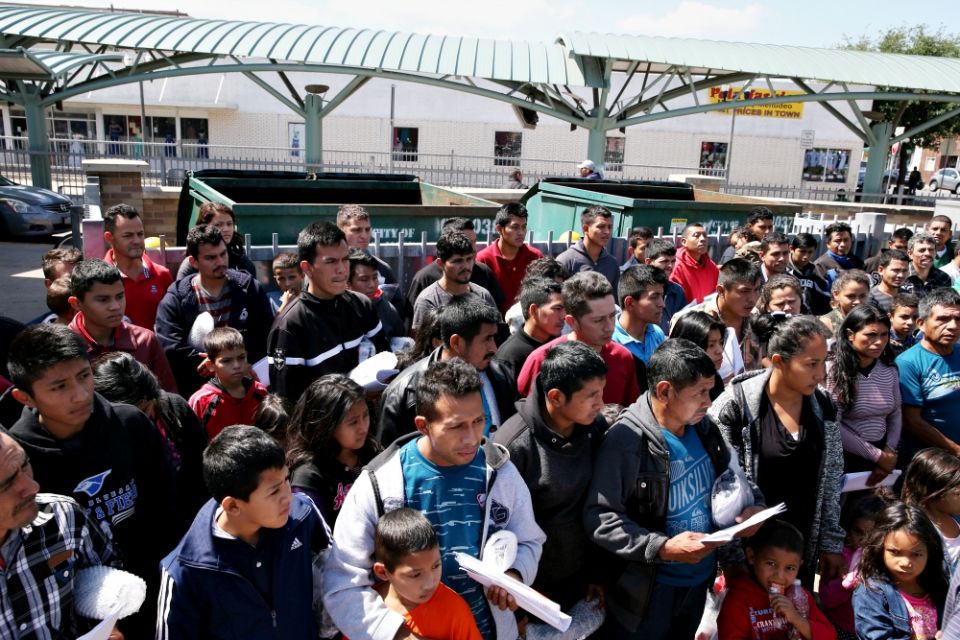Immigrants just released from detention via a U.S. immigration policy known as "catch and release" stand at a bus station April 11 before being taken to the Catholic Charities relief center in McAllen, Texas. (CNS/Reuters/Loren Elliott) Immigrants just released from detention via a U.S. immigration policy known as "catch and release" stand at a bus station April 11 before being taken to the Catholic Charities relief center in McAllen, Texas. (CNS/Reuters/Loren Elliott)