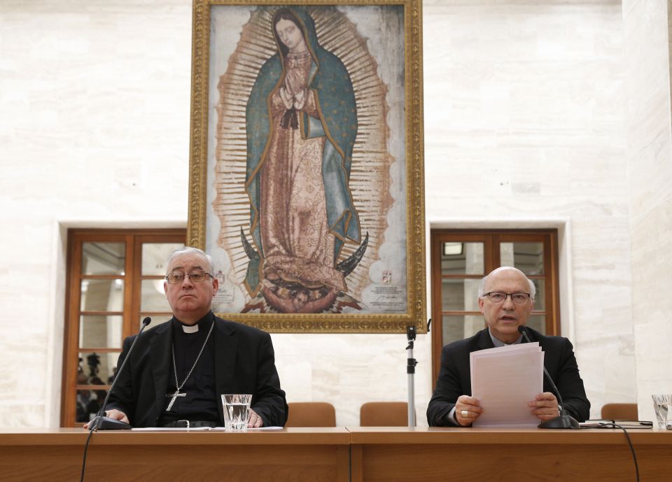 Bishop Juan Ignacio Gonzalez Errazuriz of San Bernardo, Chile, and Auxiliary Bishop Fernando Ramos Perez of Santiago, Chile, attend a press conference in Rome May 18. Bishop Gonzalez said every bishop in Chile offered his resignation to Pope Francis after