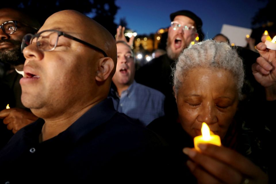 People pray during an interfaith vigil titled "Reclaiming the Integrity of Faith During Political and Moral Crisis" May 24 outside the White House in Washington. (CNS/Reuters/Jonathan Ernst)