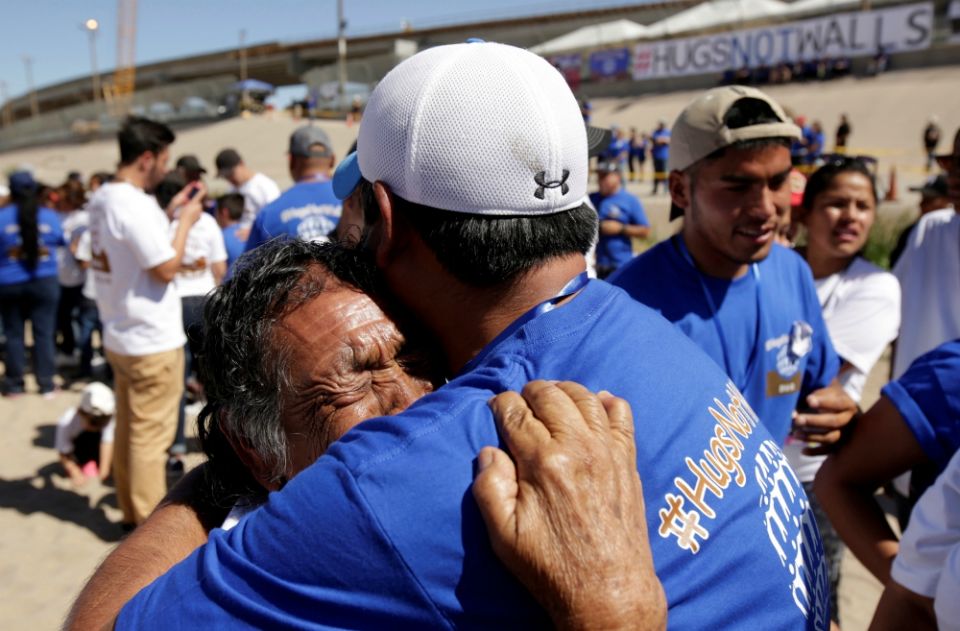 Relatives embrace as they take part in a brief reunification meeting May 2 on the border between Ciudad Juarez, Mexico, and El Paso, Texas. (CNS/Reuters/Jose Luis Gonzalez)