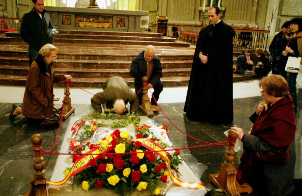 People visit the tomb of Gen. Francisco Franco in 2015 in San Lorenzo de El Escorial, Spain. In October 2019, Franco's remains were exhumed from his tomb in the Valley of the Fallen basilica, and reinterred in Madrid's Mingorrubio Cemetery. (CNS/Reuters)