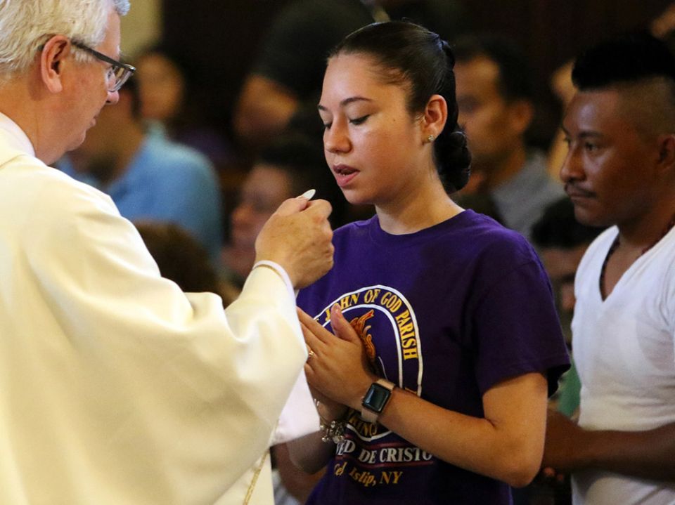A participant receives Communion during Mass at Immaculate Conception Seminary in Huntington, New York, Sept. 3, 2018, during the Rockville Centre Diocese's annual Labor Day Encuentro gathering for Latino youth and young adults. (CNS/Long Island Catholic) A participant receives Communion during Mass at Immaculate Conception Seminary in Huntington, New York, Sept. 3, 2018, during the Rockville Centre Diocese's annual Labor Day Encuentro gathering for Latino youth and young adults. (CNS/Long Island Catholic)