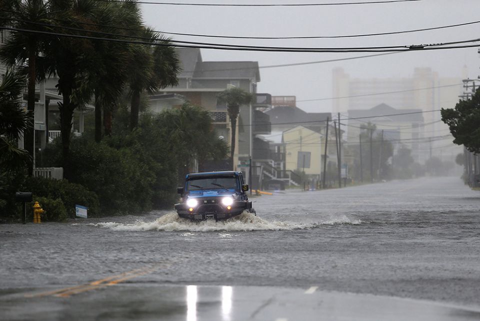 A vehicle navigates a flooded road Sept. 14, 2018, during Hurricane Florence in North Myrtle Beach, South Carolina. The next year, the coastal city of Charleston experienced 89 days of flooding, nearly one every five days. Charleston's previous record, 58