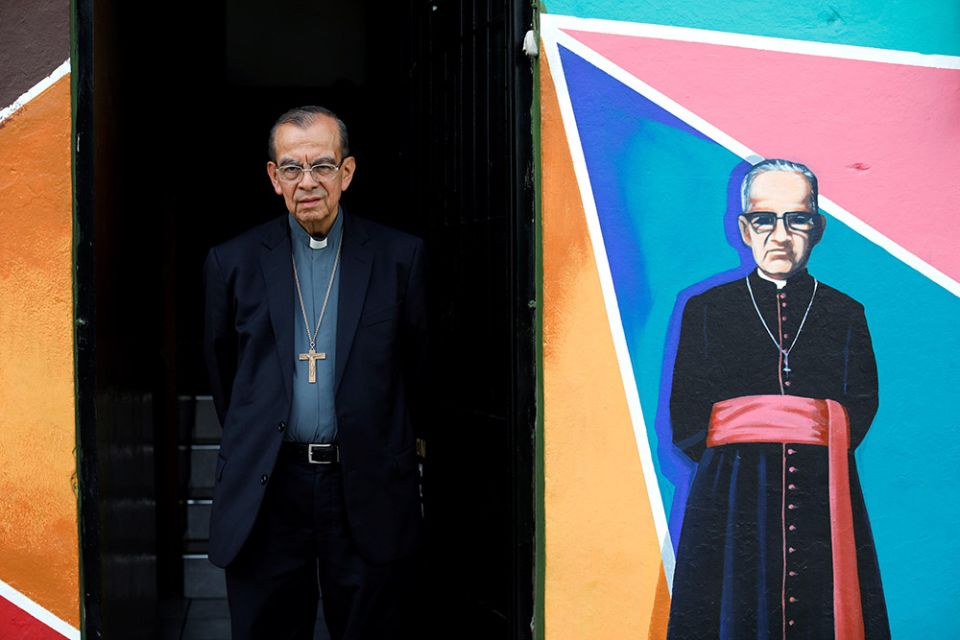 Cardinal Gregorio Rosa Chávez poses at his residence in San Salvador, El Salvador, next to a mural of St. Óscar Romero in 2018. (CNS/Reuters/Jose Cabezas)