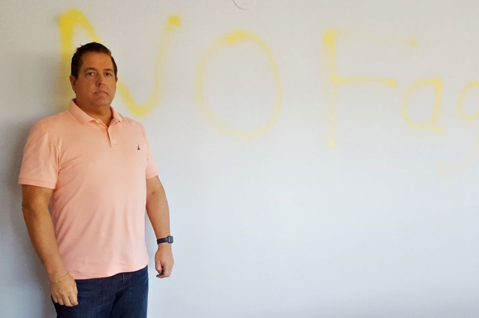 Aaron Bianco stands in St. John the Evangelist Parish's conference room, after a slur was spray-painted on a wall during an overnight break-in Oct. 14-15. (NCR photo/Dan Morris-Young)