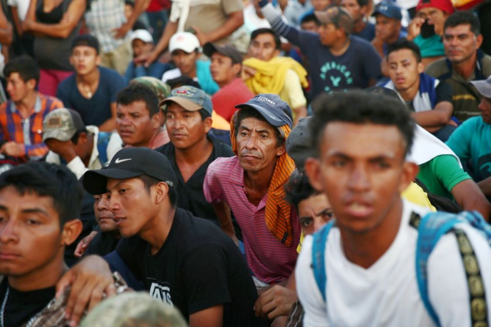 Central American migrants who are part of a caravan trying to reach the U.S. wait on a bridge Oct. 22 in Ciudad Hidalgo, Mexico. (CNS/Reuters/Edgard Garrido)