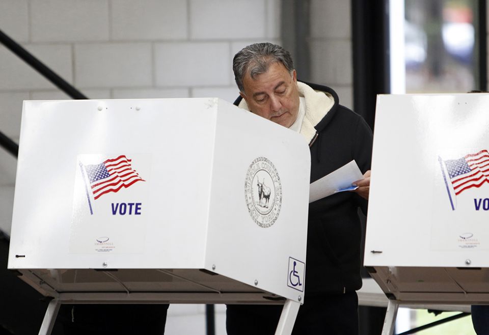 A man reviews his ballot at a polling station in Nesconset, New York, on Election Day Nov. 6, 2018. (CNS/Gregory A. Shemitz)