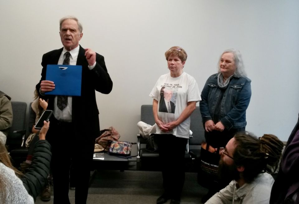 Tom Fox speaks in the Kansas City, Missouri, courthouse lobby Dec. 7 ahead of his planned trial for trespassing on the National Security Campus. Also pictured are, from left, Debbie Penniston; Linda "Lu" Mountenay; and Jordan "Sunny" Hamrick. (NCR photo)