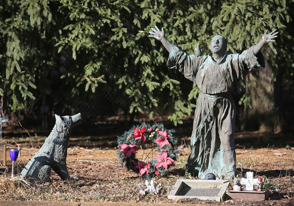 A statue on the grounds of the National Shrine of St. Maximilian Kolbe, in Libertyville, Illinois, depicts St. Francis of Assisi taming the wolf of Gubbio. (CNS/Bob Roller)
