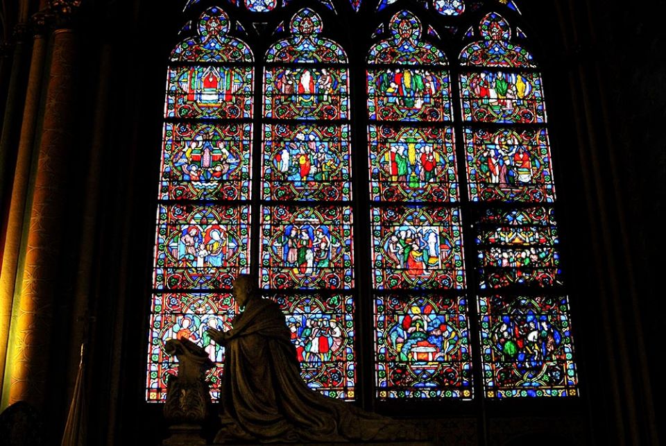Statues are silhouetted in front of stained-glass windows inside the Notre Dame Cathedral Feb. 2, 2013, in Paris. (CNS/Gerard Roussel, Panoramic via Reuters)