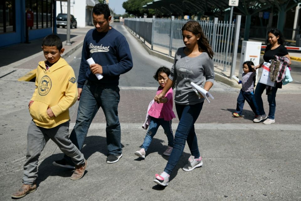 Migrant families seeking asylum walk from a bus depot to a Catholic Charities humanitarian respite center just after being released from federal detention in McAllen, Texas, July 31. (CNS/Reuters/Loren Elliott)