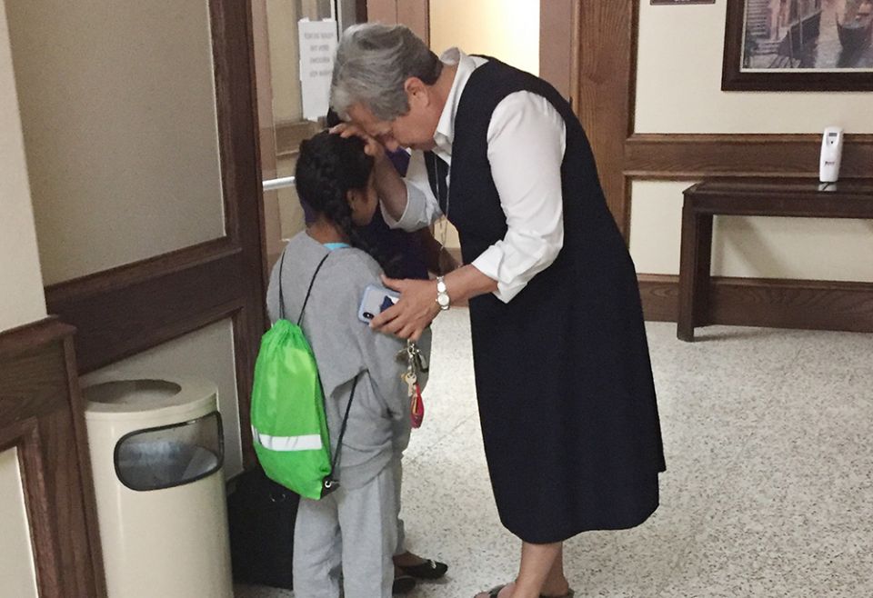 In this 2018 file photo, Sr. Norma Pimentel prays with a girl at Our Lady of San Juan National Shrine Basilica Hotel in McAllen, Texas. The child had been separated from her family. (CNS/GSR/Catholic Charities of the Rio Grande Valley) In this 2018 file photo, Sr. Norma Pimentel prays with a girl at Our Lady of San Juan National Shrine Basilica Hotel in McAllen, Texas. The child had been separated from her family. (CNS/GSR/Catholic Charities of the Rio Grande Valley)
