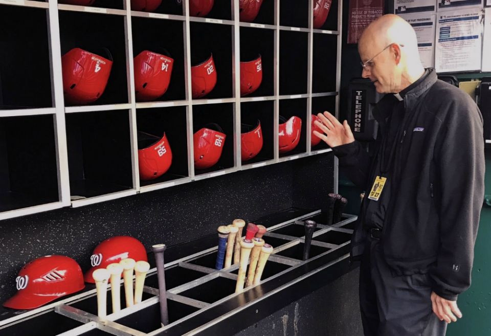 Msgr. Stephen Rossetti, a professor at the Catholic University of America and the chaplain for the Washington Nationals, blesses bats before a game during the 2019 season. (CNS/Courtesy of Msgr. Stephen J. Rossetti)