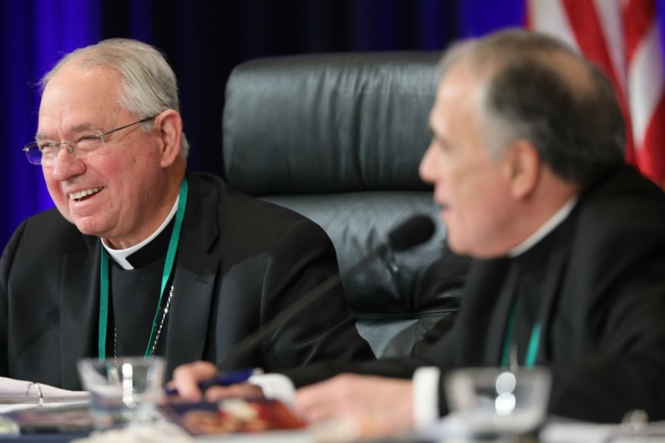 Los Angeles Archbishop José Gomez, president-elect of the U.S. Conference of Catholic Bishops, and outgoing president, Galveston-Houston Cardinal Daniel DiNardo, smile during the U.S. bishops' fall general assembly in Baltimore Nov. 13. (CNS/Bob Roller) 
