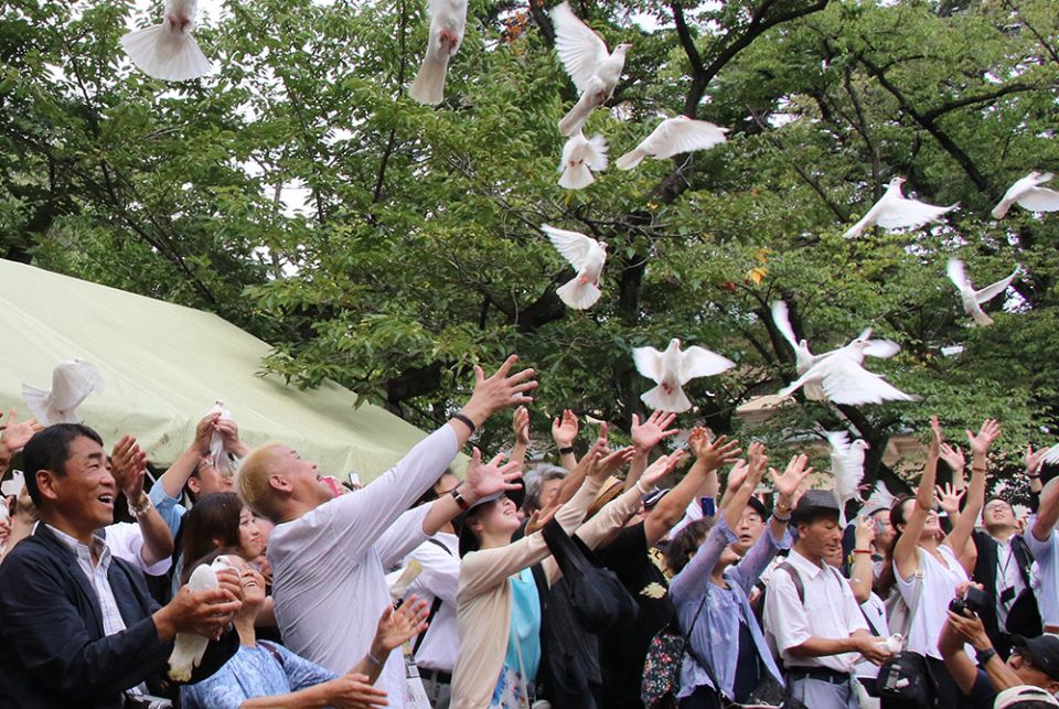 People release white doves in the air to pray for peace at the Yasukuni shrine Aug. 15, 2019, in Tokyo. (CNS/Yoshio Tsunoda, AFLO via Reuters)
