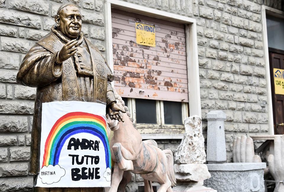 A sign reading "All will be well" hangs on a statue of St. Pope John XXIII in Zogno, Italy, near Bergamo, March 22, 2020. (CNS/Reuters/Flavio Lo Scalzo)