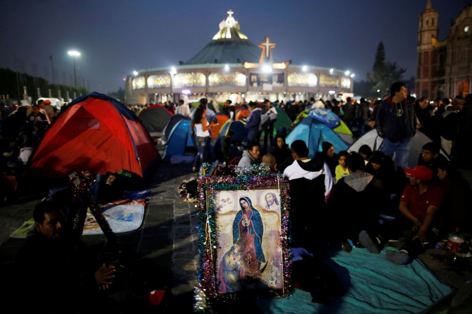 Image of Our Lady of Guadalupe at the Basilica of Our Lady of Guadalupe in Mexico City Pilgrims rest beside an image of Our Lady of Guadalupe Dec. 11, 2018, the eve of her feast day at the Basilica of Our Lady of Guadalupe in Mexico City. (CNS)