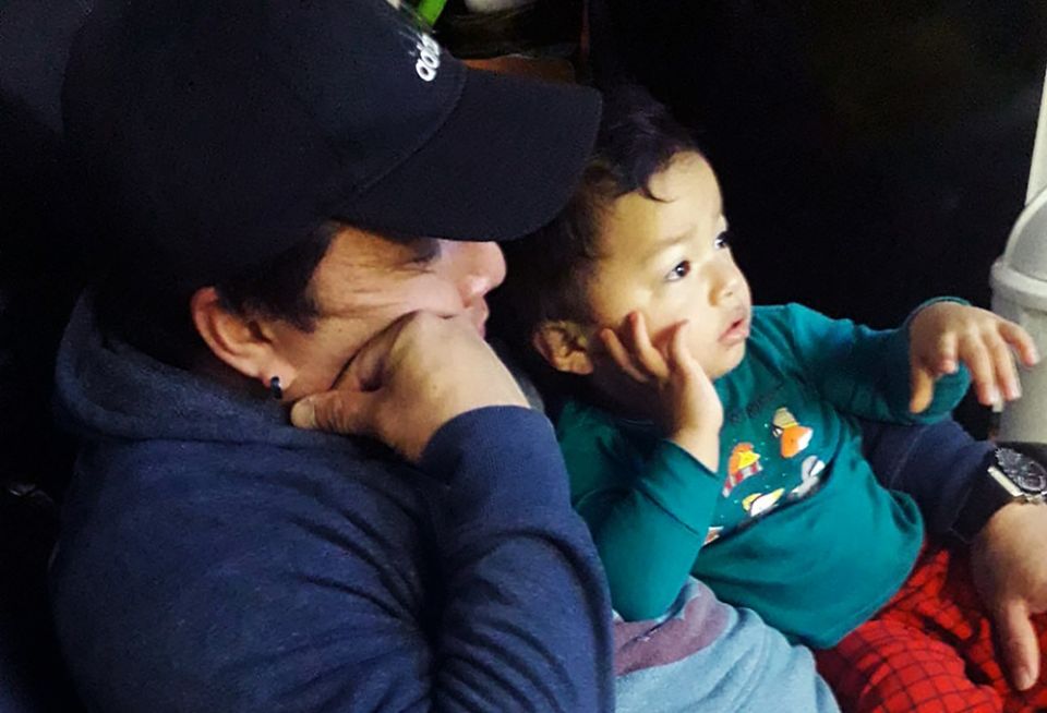 Juan Vasquez, a grocery store worker in Uniondale, New York, cuddles with his toddler Robert while watching TV at home March 28, 2020. (CNS/Courtesy of Tanya Granillo de Vasquez) Juan Vasquez, a grocery store worker in Uniondale, New York, cuddles with his toddler Robert while watching TV at home March 28, 2020. (CNS/Courtesy of Tanya Granillo de Vasquez)
