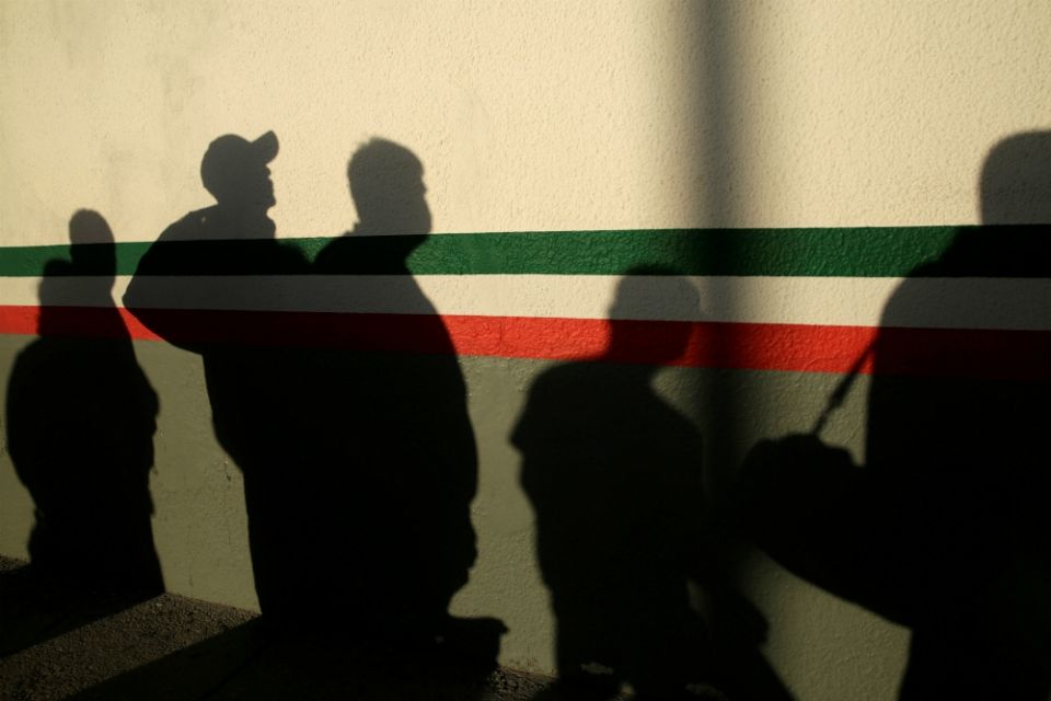 Immigrants in Ciudad Juárez, Mexico, cast shadows on a National Institute of Migration building after they were deported from the United States April 21 during the coronavirus pandemic. (CNS/Reuters/Jose Luis Gonzalez) Immigrants in Ciudad Juárez, Mexico, cast shadows on a National Institute of Migration building after they were deported from the United States April 21 during the coronavirus pandemic. (CNS/Reuters/Jose Luis Gonzalez)