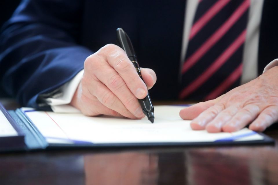 President Donald Trump signs the Paycheck Protection Program and Health Care Enhancement Act at the White House in Washington April 24. (CNS/Reuters/Jonathan Ernst)