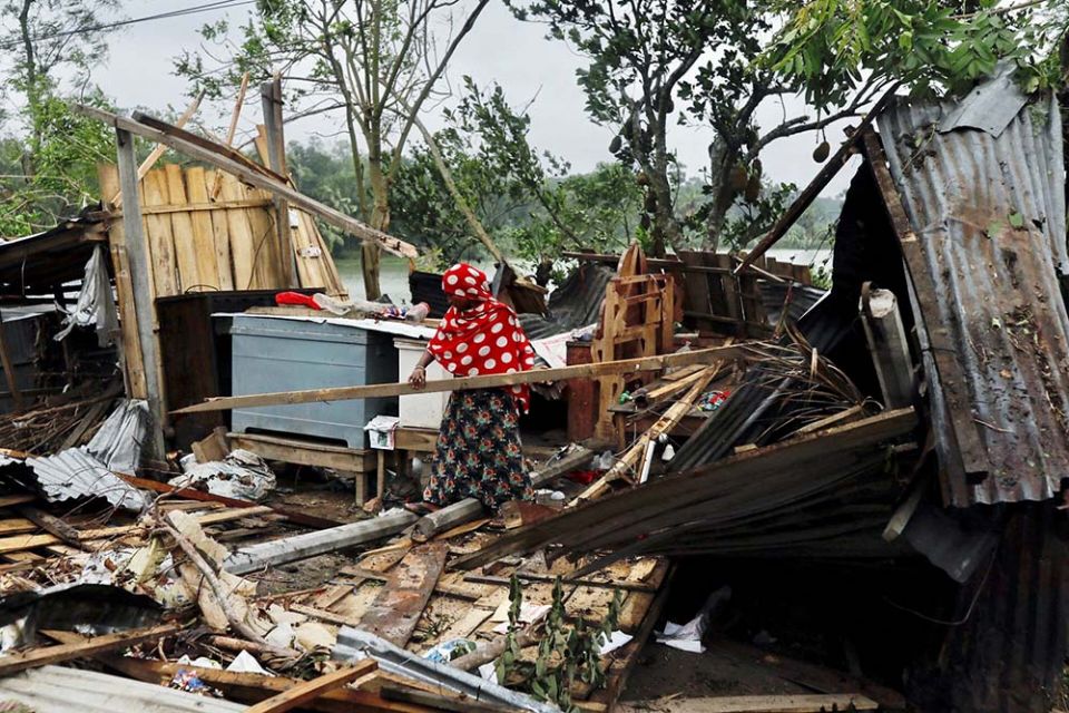 A woman moves debris at the site of her house, demolished by Cyclone Amphan, in Satkhira, Bangladesh, May 21, 2020. (CNS/Reuters/Km Asad)