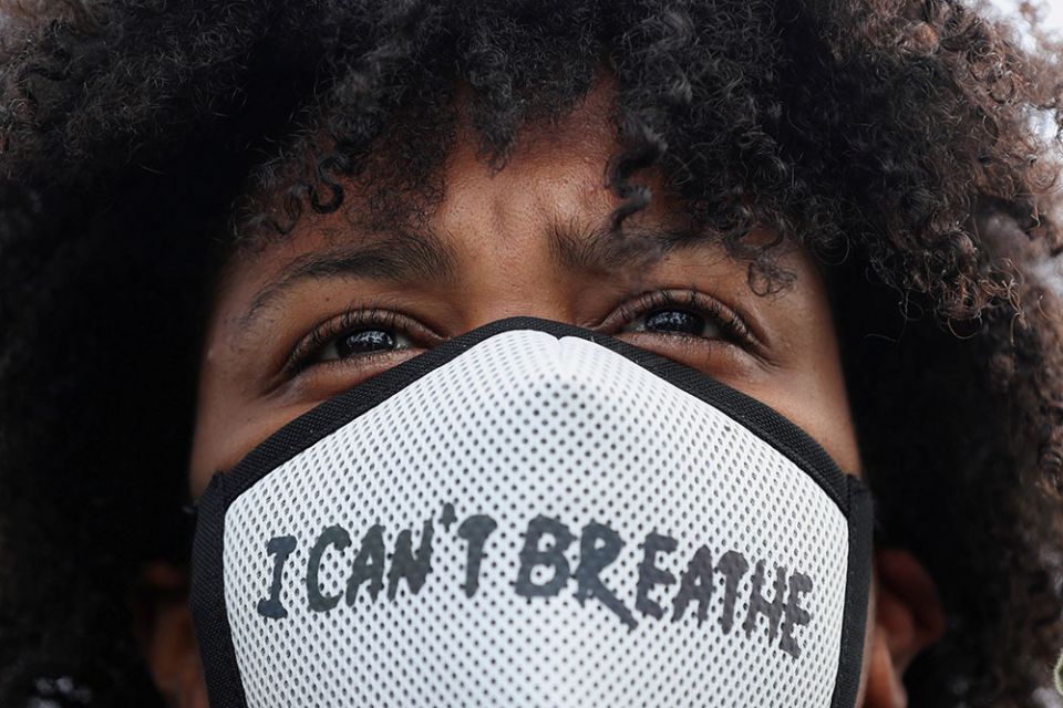 A demonstrator wearing a protective mask takes part in a protest in Rotterdam, Netherlands, June 3, 2020, following the death of George Floyd. (CNS/Reuters/Eva Plevier)