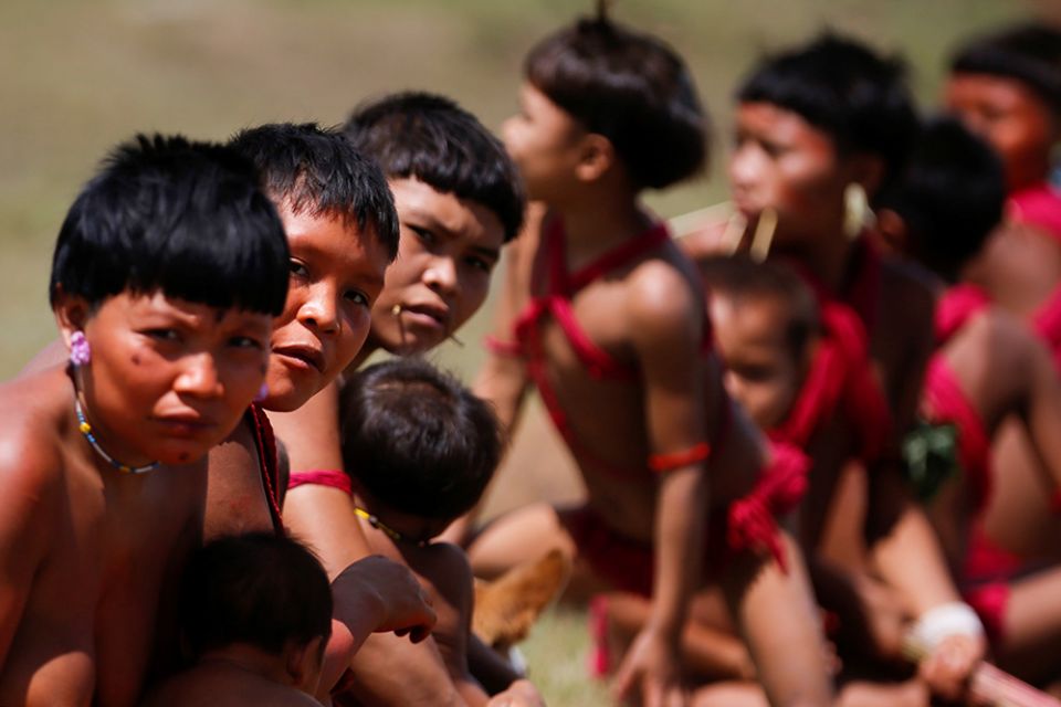 Young Yanomami look on as members of a medical team with the Brazilian army examine members of the Indigenous tribe in the state of Roraima July 1, 2020, during the COVID-19 pandemic. (CNS/Reuters/Adriano Machado)