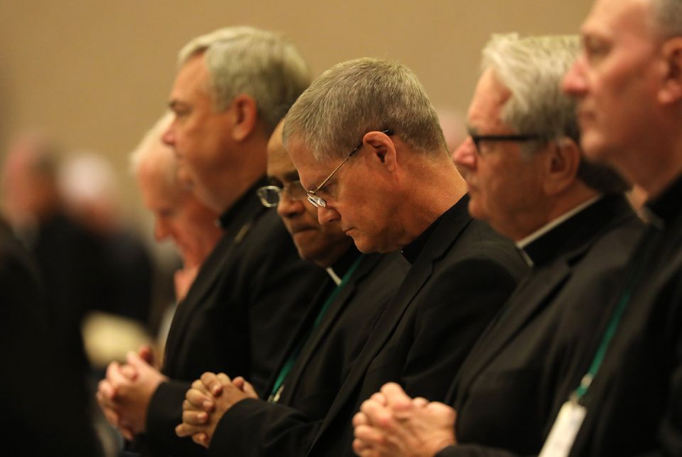 Archbishop Paul Etienne of Seattle, center, and other prelates pray during the fall general assembly of the U.S. Conference of Catholic Bishops Nov. 12, 2019, in Baltimore. (CNS) Archbishop Paul Etienne of Seattle, center, and other prelates pray during the fall general assembly of the U.S. Conference of Catholic Bishops Nov. 12, 2019, in Baltimore. (CNS)