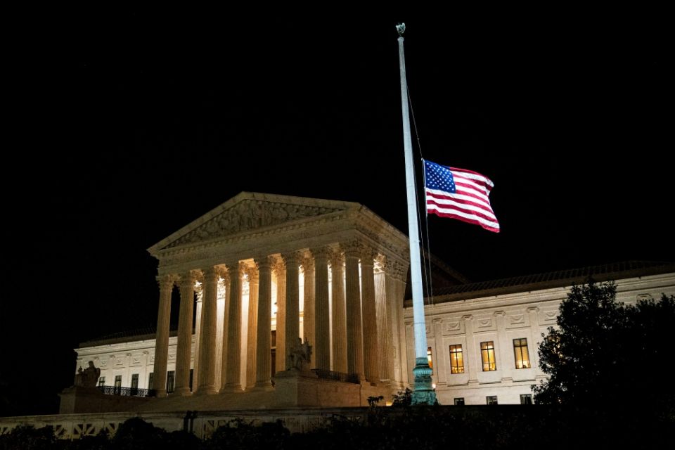 The American flag flies at half staff outside of the U.S. Supreme Court in Washington Sept. 18 following the death of U.S. Supreme Court Justice Ruth Bader Ginsburg. (CNS/Reuters/Al Drago) The American flag flies at half staff outside of the U.S. Supreme Court in Washington Sept. 18 following the death of U.S. Supreme Court Justice Ruth Bader Ginsburg. (CNS/Reuters/Al Drago)