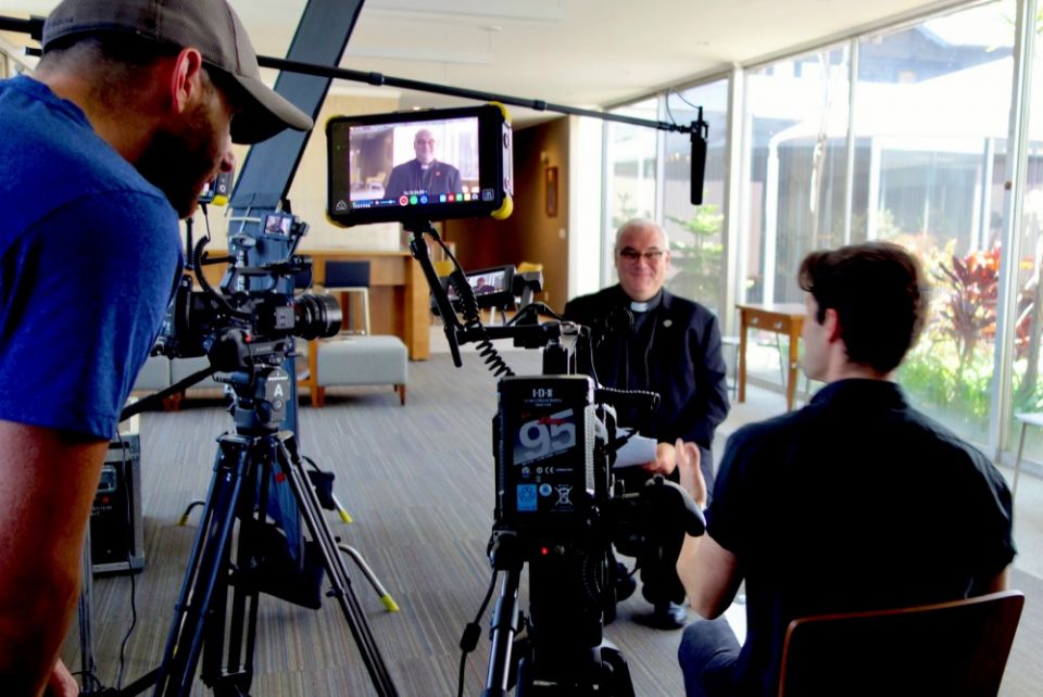 Jonathan Cipiti interviews Holy Cross Fr. David Guffey at the Family Theater Productions offices in Los Angeles in 2018 during the making of the 2020 documentary "Pray: The Story of Patrick Peyton." (CNS/Family Theater Productions)