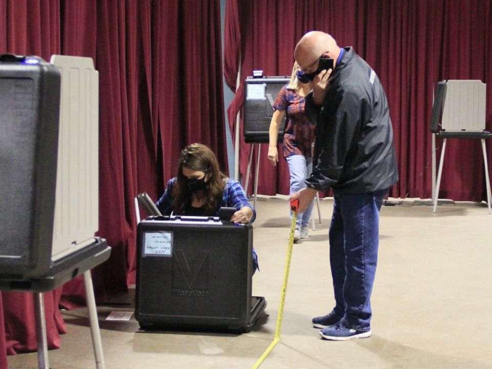 Volunteers in Fort Wayne, Indiana, set up voting machines Oct. 5 for early voting. (CNS/Today’s Catholic/Jodi Marlin)
