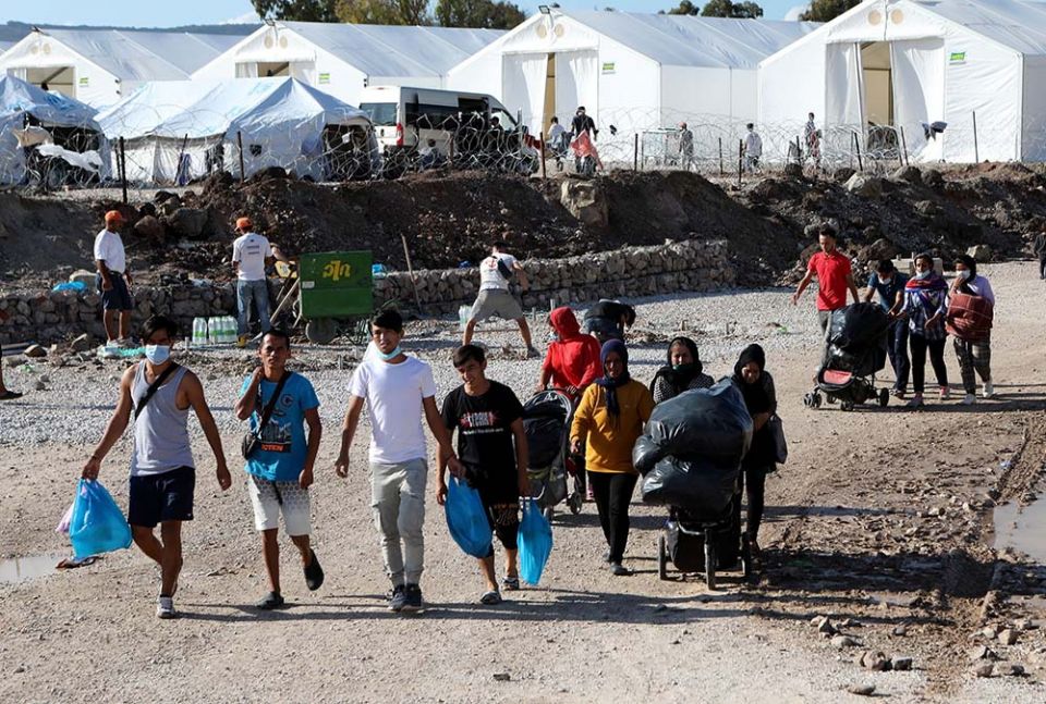 Migrants walk with their belongings as they make their way to the Kara Tepe refugee camp on the Greek island of Lesbos Oct. 14, 2020. (CNS/Reuters/Elias Marcou) Migrants walk with their belongings as they make their way to the Kara Tepe refugee camp on the Greek island of Lesbos Oct. 14, 2020. (CNS/Reuters/Elias Marcou)