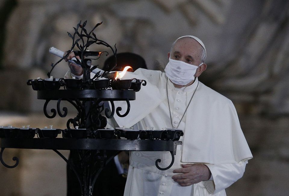 Pope Francis lights a candelabra at the conclusion of an encounter to pray for peace in Piazza del Campidoglio in Rome Oct. 20. (CNS/Paul Haring) Pope Francis lights a candelabra at the conclusion of an encounter to pray for peace in Piazza del Campidoglio in Rome Oct. 20. (CNS/Paul Haring)