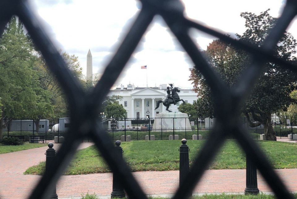 The White House and the Washington Monument are seen in the distance past a fence Nov. 2. Buildings in the District of Columbia and in other U.S. cities were being boarded up in anticipation of violence breaking out over results of the Nov. 3 elections. (