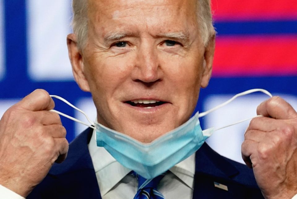 Joe Biden removes his face mask to speak about the presidential election results during an appearance in Wilmington, Delaware, Nov. 4. (CNS/Reuters/Kevin Lamarque)