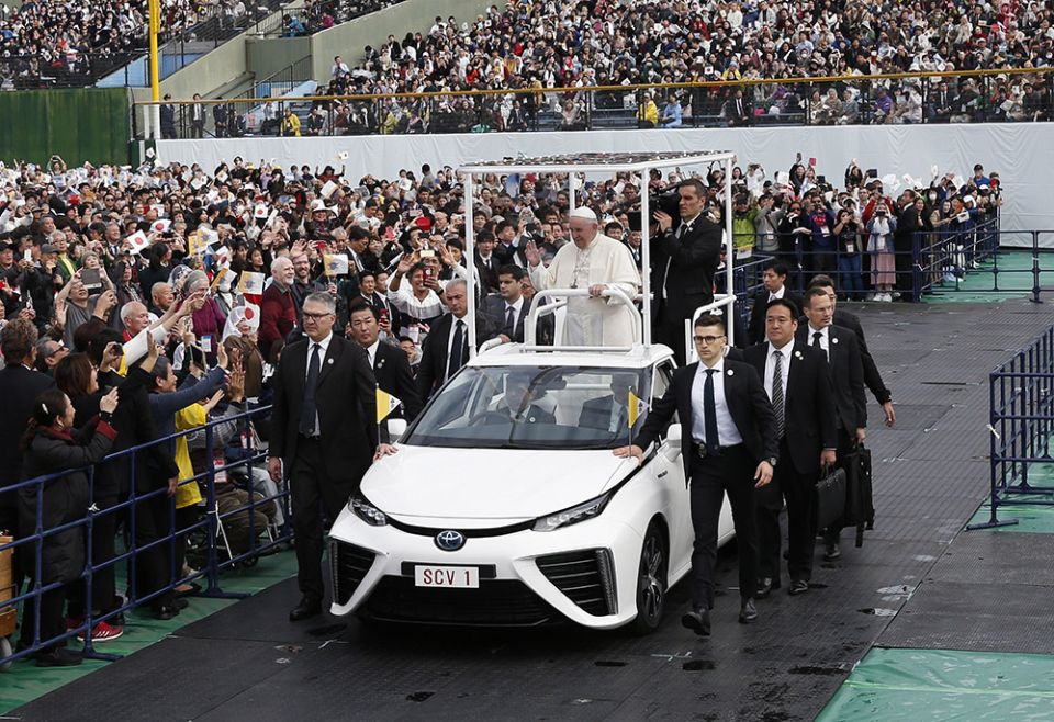 Pope Francis rides in a hydrogen-powered Toyota vehicle as he greets the crowd before celebrating Mass at the baseball stadium Nov. 24, 2019, in Nagasaki, Japan. (CNS/Paul Haring)