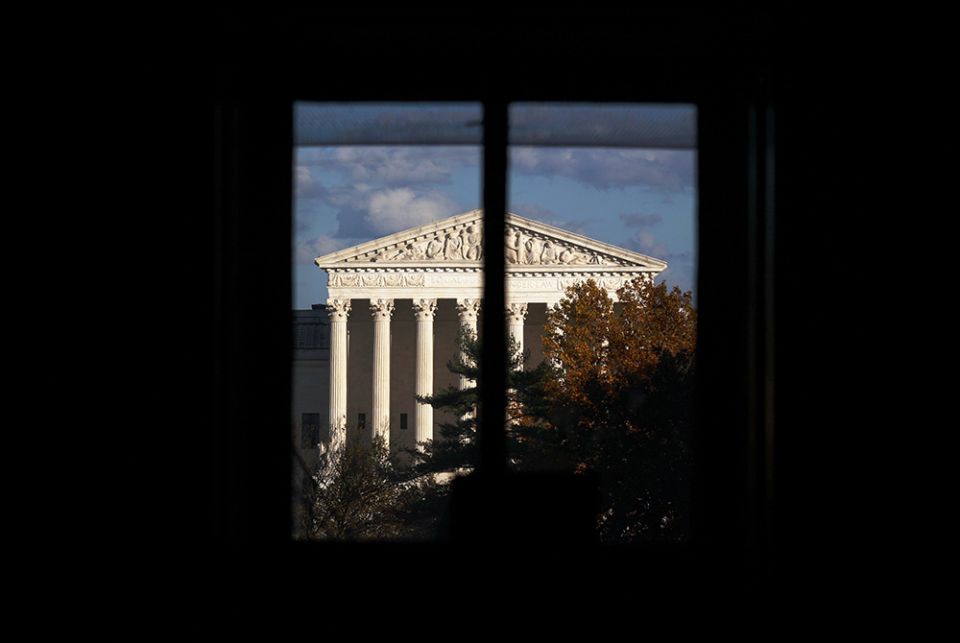 The Supreme Court building is seen through a window Nov. 10 in Washington. (CNS/Hannah McKay, Reuters)
