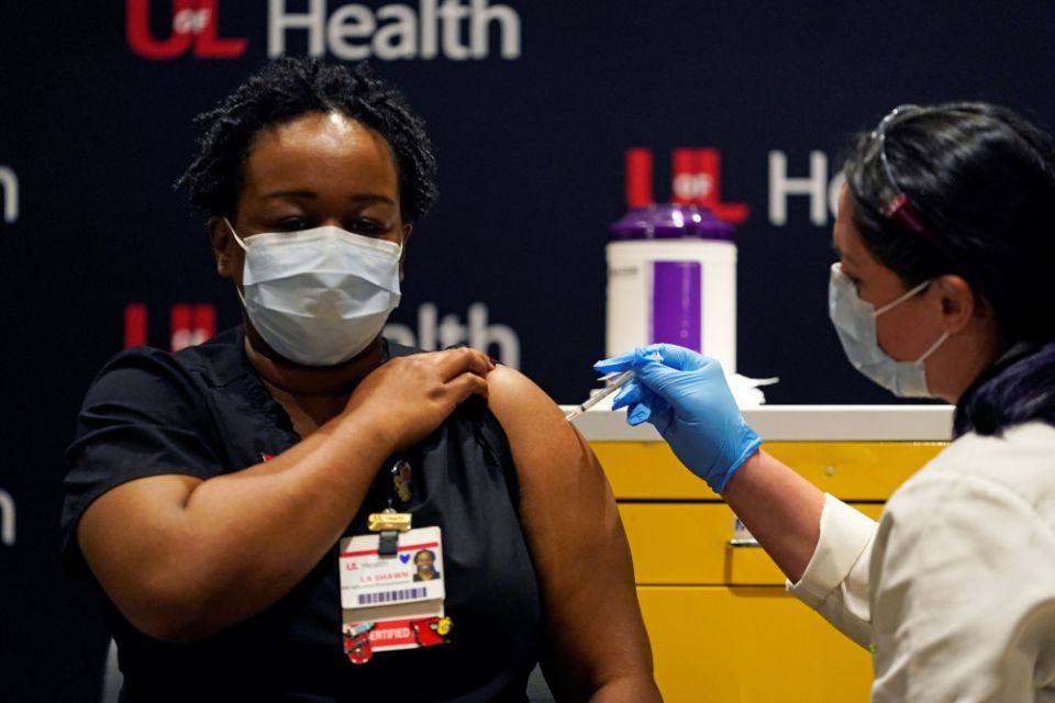 LaShawn Scott, a nurse at University of Louisville Hospital, is inoculated with the Pfizer coronavirus vaccine at the Louisville, Kentucky, health care facility Dec. 14. (CNS/Reuters/Bryan Woolston)