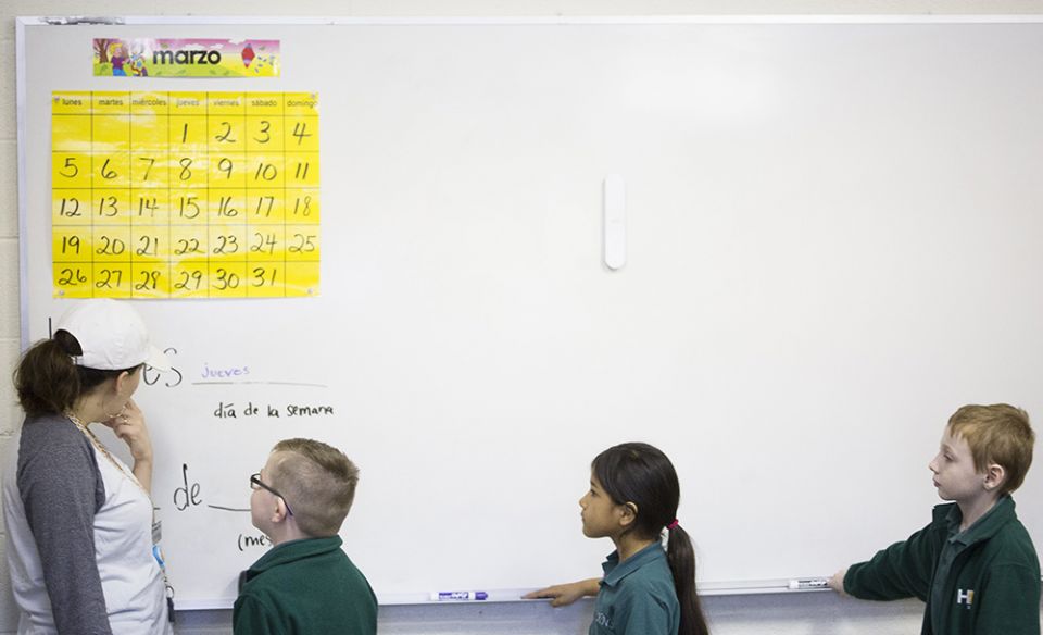 Second-grade students at Holy Name of Jesus Catholic School in Henderson, Kentucky, help Susana Solorza, the school's Spanish teacher, fill in the day's Spanish calendar March 29, 2018. (CNS/Tyler Orsburn)
