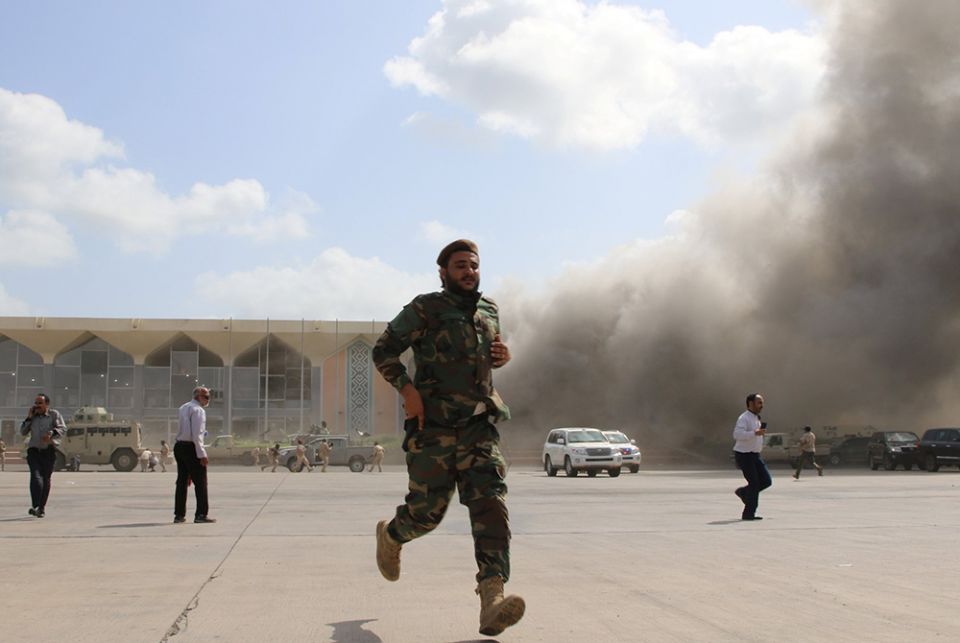 A security member runs during an attack on the airport in Aden, Yemen, Dec. 30, 2020, moments after a plane landed carrying a newly formed Cabinet for government-held parts of the country. (CNS/Fawaz Salman, Reuters)