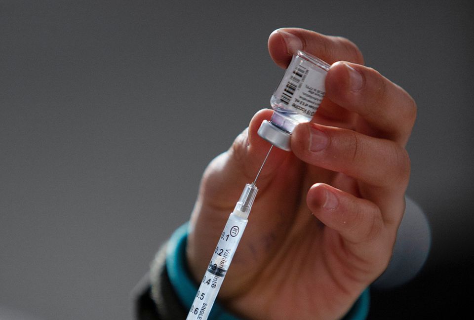 A health care worker administers COVID-19 vaccines at a mass vaccination site in Ridgefield, Washington, Jan. 27. (CNS/Reuters/Alisha Jucevic)