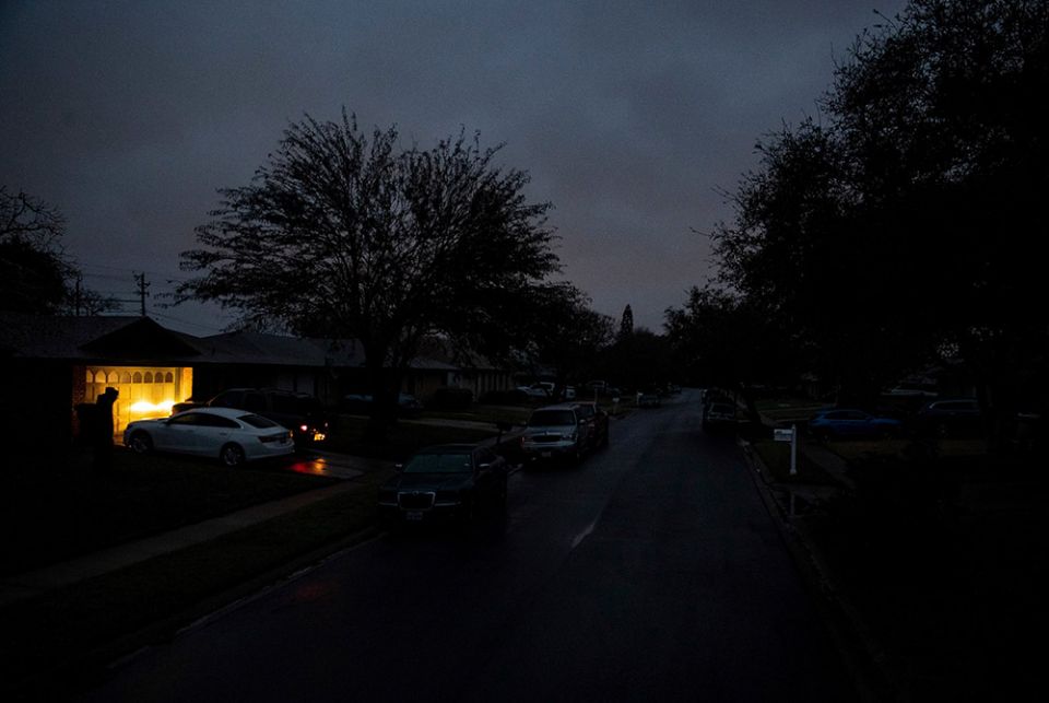 A car in Corpus Christi, Texas, idles Feb. 17 in a neighborhood that has no electricity. (CNS/Courtney Sacco, Caller-Times, USA Today Network via Reuters)