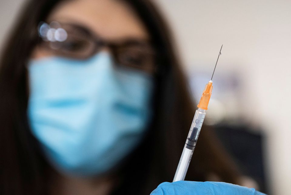 A nurse in Richmond, Virginia, readies a syringe with the COVID-19 vaccine at the Richmond Raceway complex March 4. (CNS/Julia Rendleman, Reuters)