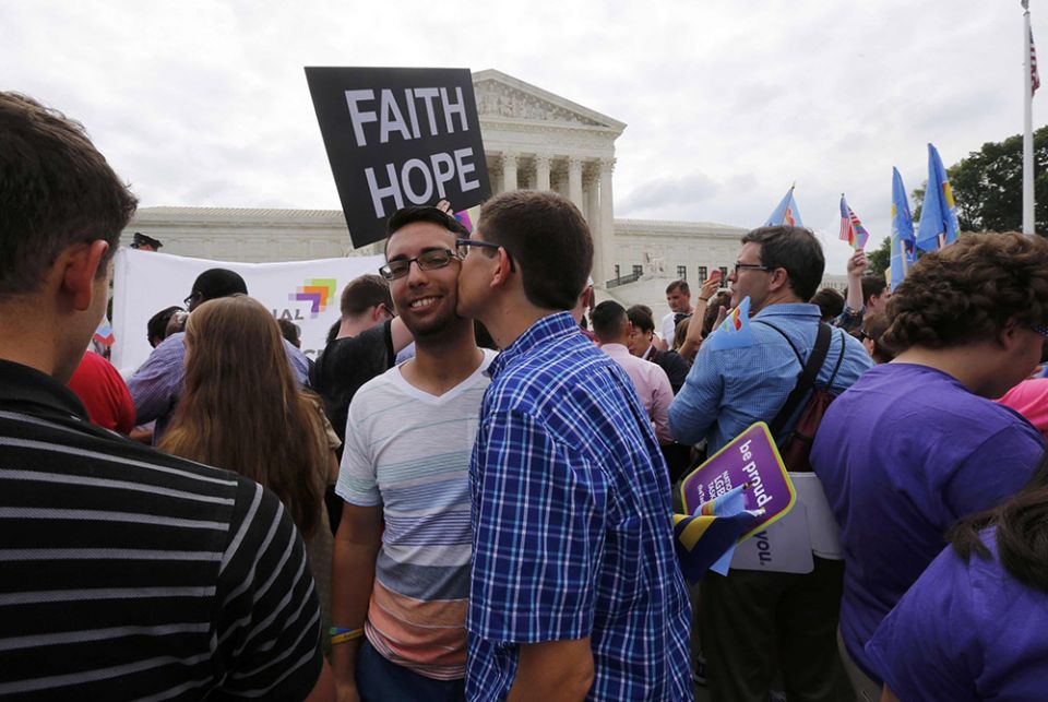 Supporters of same-sex marriage celebrate outside the U.S. Supreme Court building in Washington June 26, 2015, after the justices ruled in a 5-4 decision that the U.S. Constitution gives same-sex couples the right to marry. Over 3,000 Catholic theologians