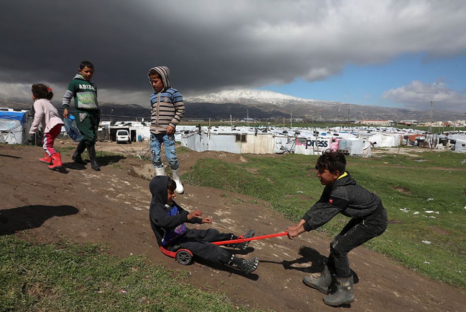 Syrian refugee children play together at an informal tent settlement in the Bekaa Valley in Lebanon March 12. (CNS/Reuters/Mohamed Azakir)