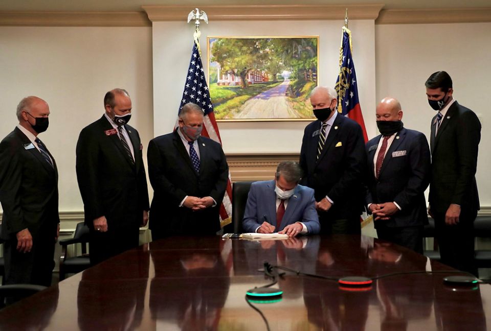Georgia Gov. Brian Kemp signs the Election Integrity Act of 2021 in Atlanta March 25. (CNS/Gov. Brian Kemp, Twitter, Handout via Reuters) Georgia Gov. Brian Kemp signs the Election Integrity Act of 2021 in Atlanta March 25. (CNS/Gov. Brian Kemp, Twitter, Handout via Reuters)