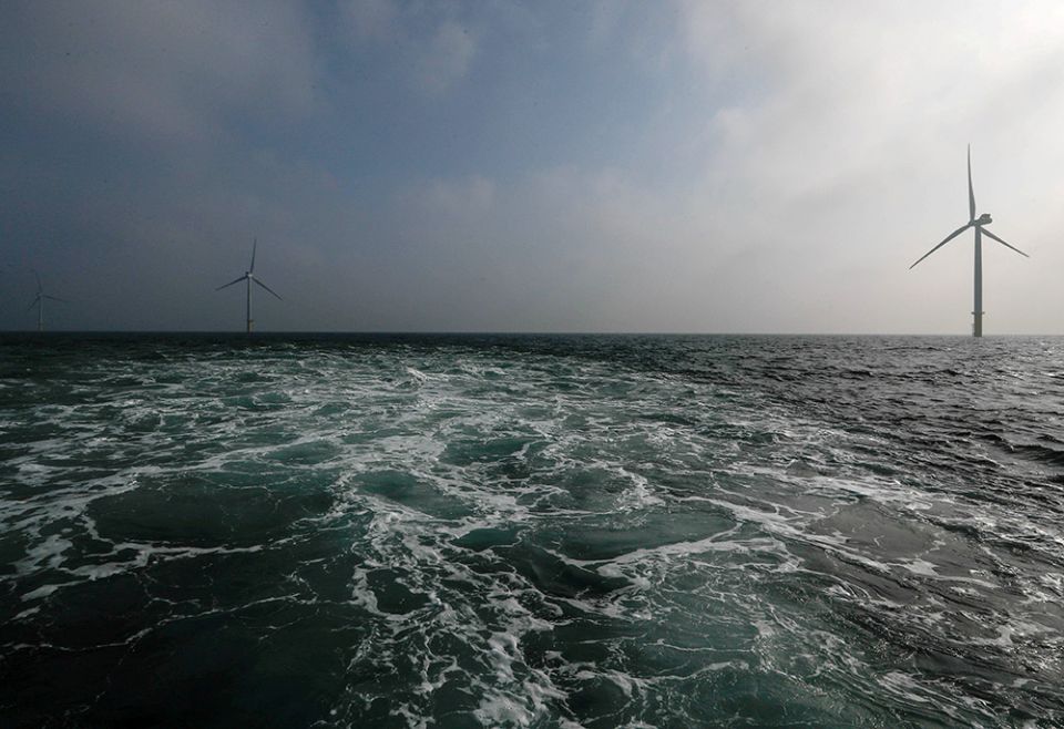 Windmill turbines are seen offshore near Amsterdam, Netherlands, in 2017. (CNS/Reuters/Yves Herman)