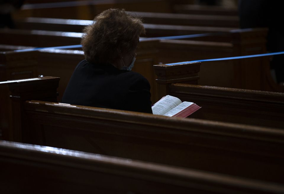 A woman reads the Bible before Mass at the Basilica of the National Shrine of the Immaculate Conception March 11, 2021, in Washington. (CNS/Tyler Orsburn)