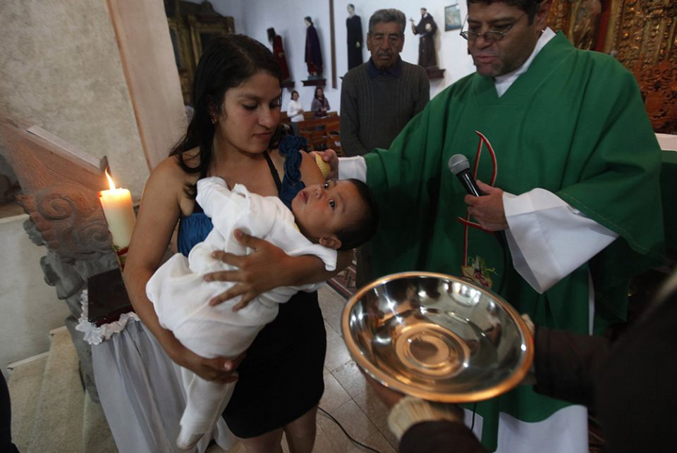 A child is pictured in a file photo being baptized at a church in Mexico City. (CNS/Reuters/Edgard Garrido)