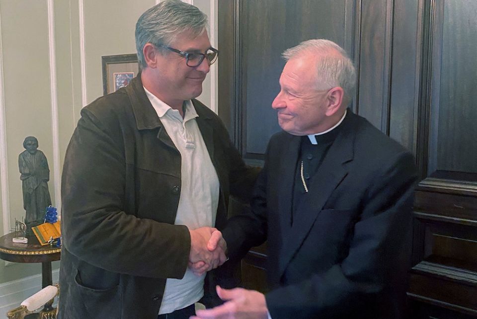 New Orleans Archbishop Gregory Aymond greets Kevin Bourgeois, leader of the New Orleans chapter of Survivors Network of those Abused by Priests, at the archdiocesan chancery Dec. 15, 2020. (CNS/Courtesy of Archdiocese of New Orleans)